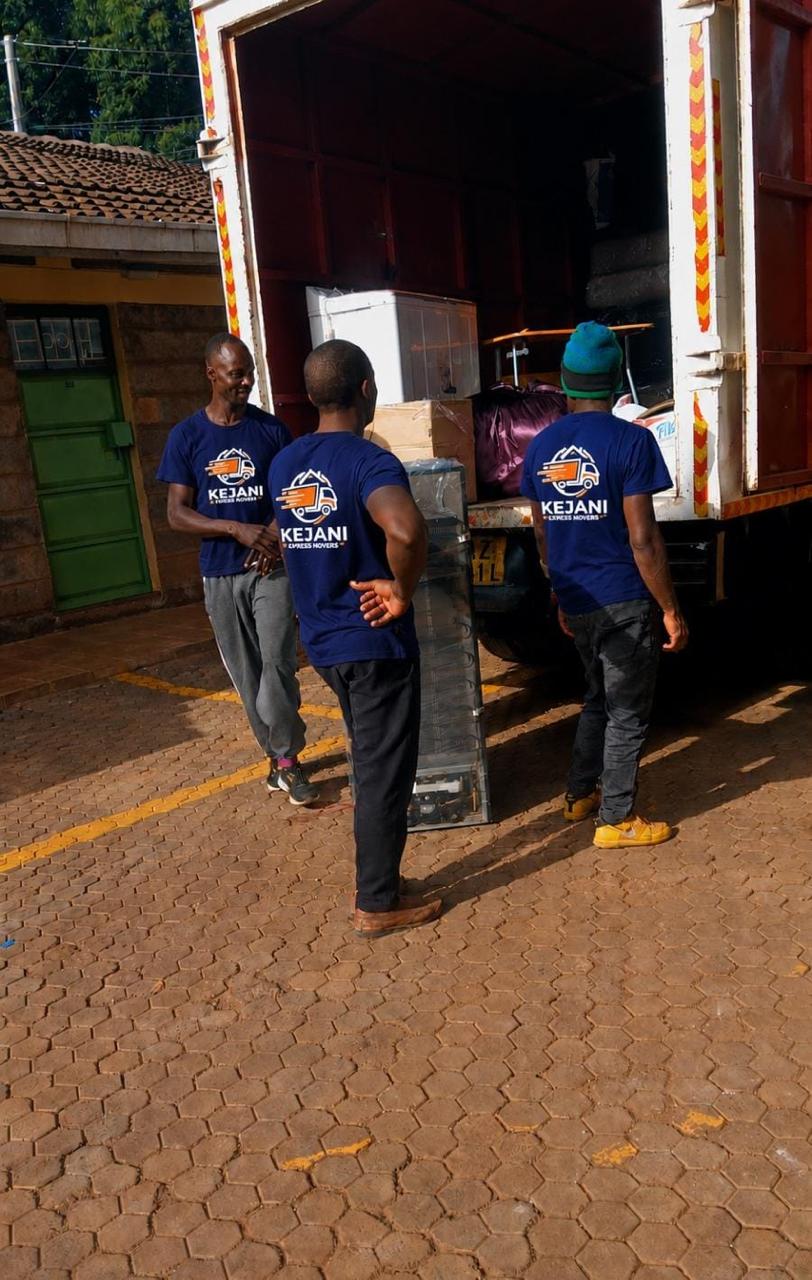 Kejani movers in branded t-shirts at the truck